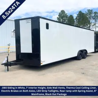 Long white enclosed cargo trailer with black front, dual axles, parked on a lot; overlay lists specs: 8.5x24TA, 7' interior height, wall vents, LED taillights, rear ramp with spring assist, and other features