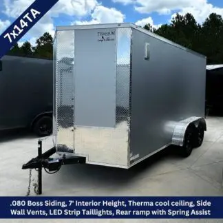 Silver enclosed cargo trailer with diamond-plate accents, 7' interior height, tandem axles, and a front hitch for towing.