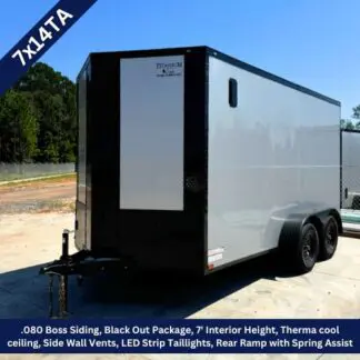 Enclosed cargo trailer with 7' interior height and black front; tandem-axle with side vents and rear spring-assisted ramp (Titanium/Black Out).