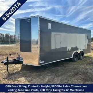 Enclosed twin-axle cargo trailer on a dirt lot; front hitch and dark gray body with a spec overlay showing 8.5x20TA and 7' interior height