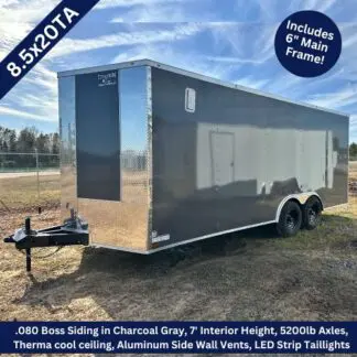 Titanium Cargo 8.5×20 Tandem Axle Charcoal Gray Enclosed Cargo Trailer ‣ Boss Cargo Trailers Enclosed 8.5x20-foot charcoal gray cargo trailer with dual axles and diamond-plate front, on a dirt lot with hitch visible.