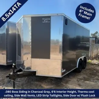 8.5×14 Tandem Axle Charcoal Gray Enclosed Cargo Trailer ‣ Boss Cargo Trailers Two-axle enclosed cargo trailer with charcoal siding and diamond-plate front, parked on a dirt lot under a clear sky.