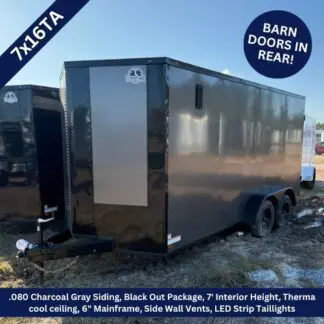 Black enclosed dual-axle trailer with a diamond-plate front, parked on dirt; features charcoal gray siding, black-out package, 7' interior height, LED strip taillights, and barn doors in the rear.