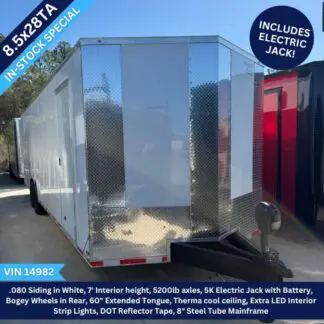 Enclosed cargo trailer with diamond-plate front, white sides, and electric jack at the hitch; in-stock special banner visible.