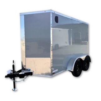 Enclosed silver cargo trailer with dual axles and a hitch, viewed from the front-left