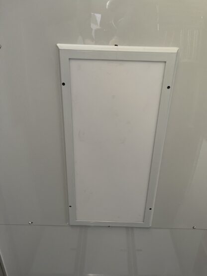 A white panel on the ceiling of a room.