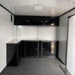 The inside of a black and white enclosed trailer.