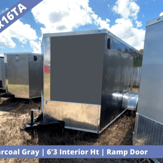 A group of Charcoal Gray 7X16 Tandem Axle Trailers in a field.