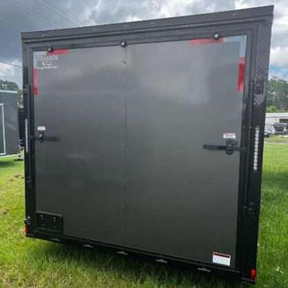 A black trailer with red trim on the side.