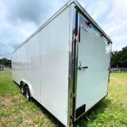 A white trailer with two doors and no wheels.