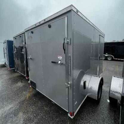 A trailer with a large metal door and wheels.