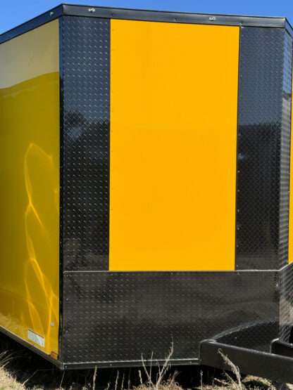 A yellow and black panel on the side of a truck.