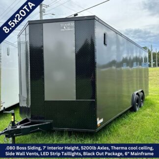Black 8.5x20TA tandem-axle enclosed cargo trailer with a diamond-plate front, side vent, LED taillights, and a front hitch on a grassy lot.