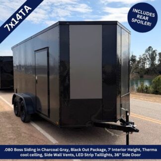 Black enclosed dual-axle cargo trailer with side entry door, diamond-plate front, and trailer hitch parked on a road near trees and water.